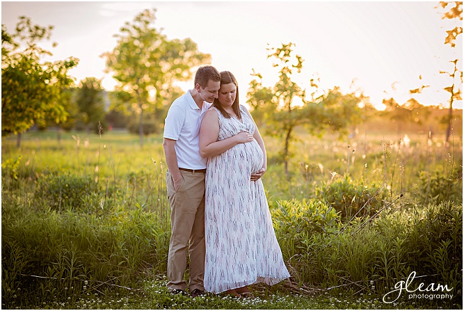 Outdoor maternity during sunset in a field of tall grasses