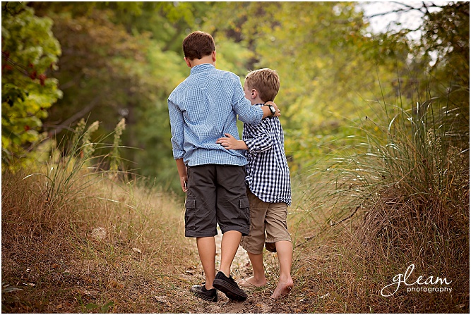 boys, siblings walking away from camera in a hug